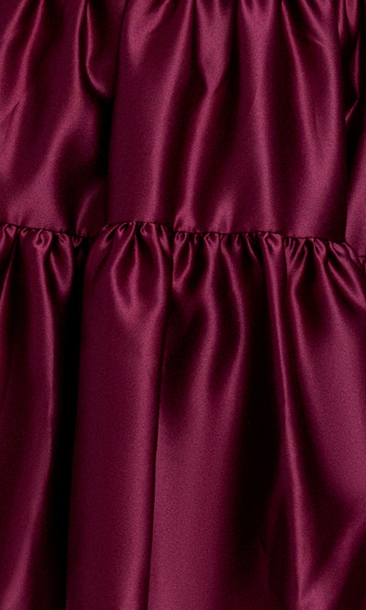 Close-up of burgundy satin with ruched, shiny texture, featured on the affordable Blondie Nites 6204BN Wine Red Mini Hoco Dress—perfect as a strapless short homecoming dress in junior sizes.
